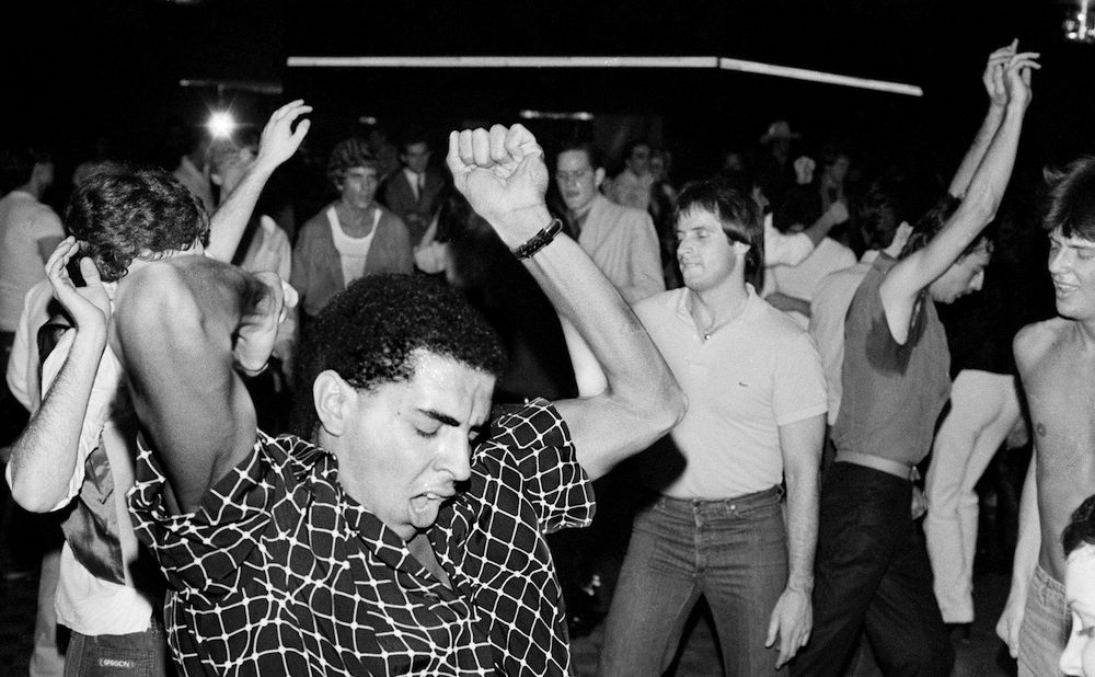 Black and white photo of people dancing in club