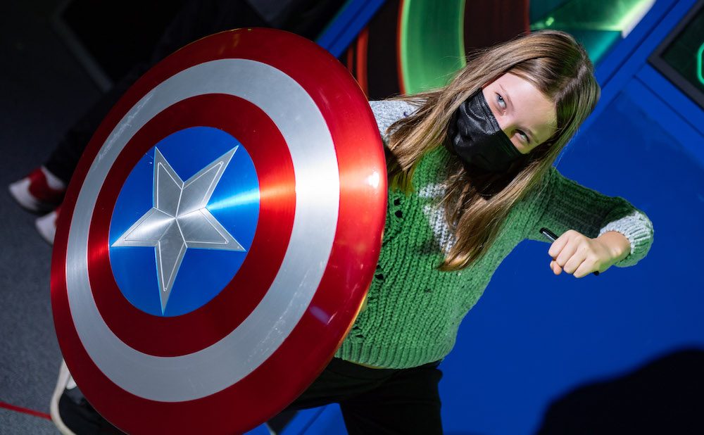 girl holding Captain America shield