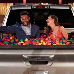 Couple from the Bachelorette in truck bed full of plastic balls