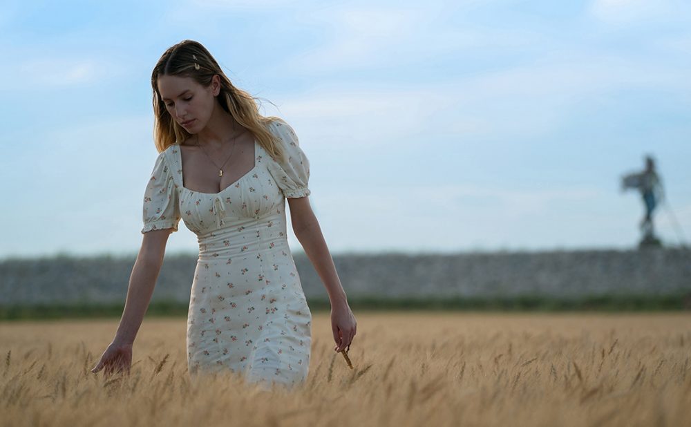 Dylan Penn walking through a wheat field in the movie Flag Day.