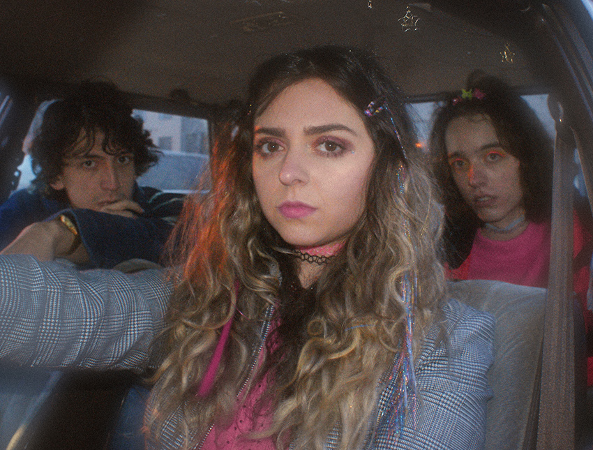 Jonny Fig (left), Demi Demitro and Baby Pottersmith of The Velveteers sitting in a car.