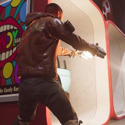 Video game still from Deathloop of a man in a leather jacket shooting a gun.
