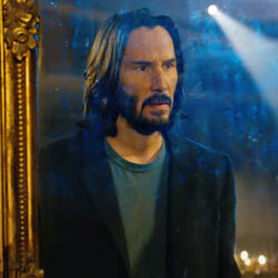 Keanu Reeves looking into a mirror, from the film The Matrix Resurrections.
