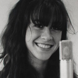 A black and white photo of a young Alanis Morissette.
