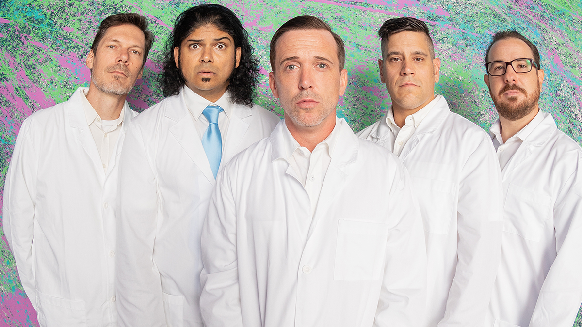 Billy Talent in lab coats against a painted wall.