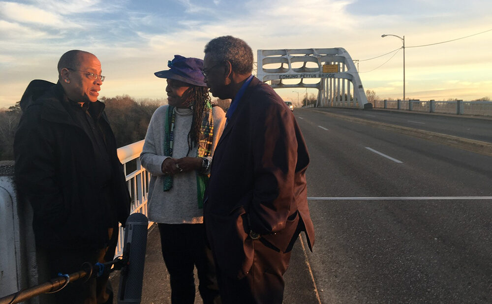 Film Still of Jeffery Robinson with Faya Ora Rose Touré and Senator Hank Sanders on the Edmund Pettus Bridge, Selma, Alabama.