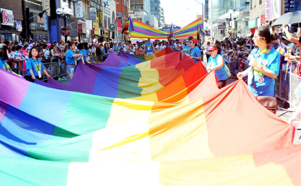 Pride Flag being carried down street