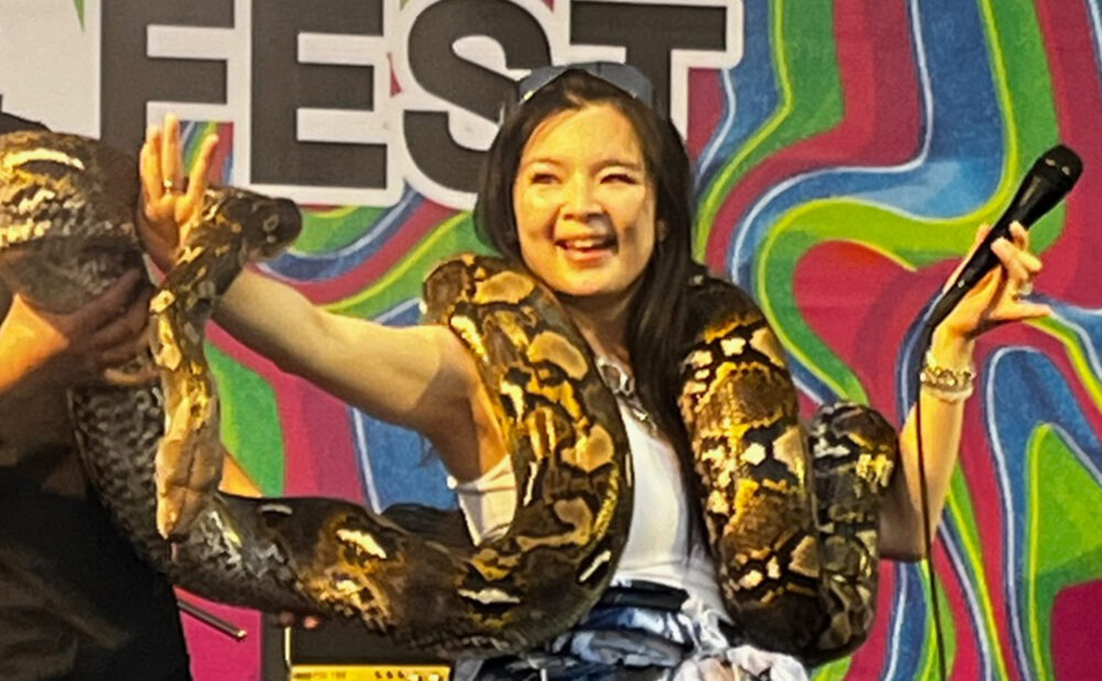 Aiko Tomi uses a fan's snake at her Jade Fest show in Taipei, Taiwan. She plays NXNE, Thurs,, June 13 (Bar Cathedral)